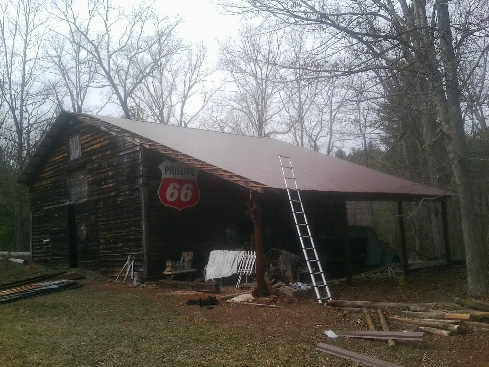 New metal roof on an open sided timber barn with a vintage sign in Clinton